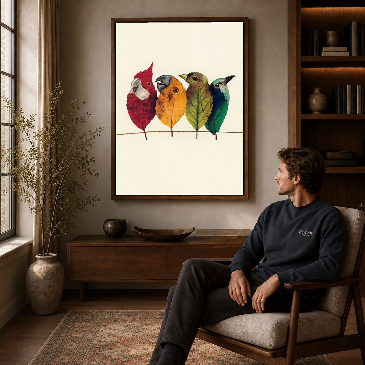 Walnut framed autumn leaf birds artwork above a seated man in a wood furnished living room.
