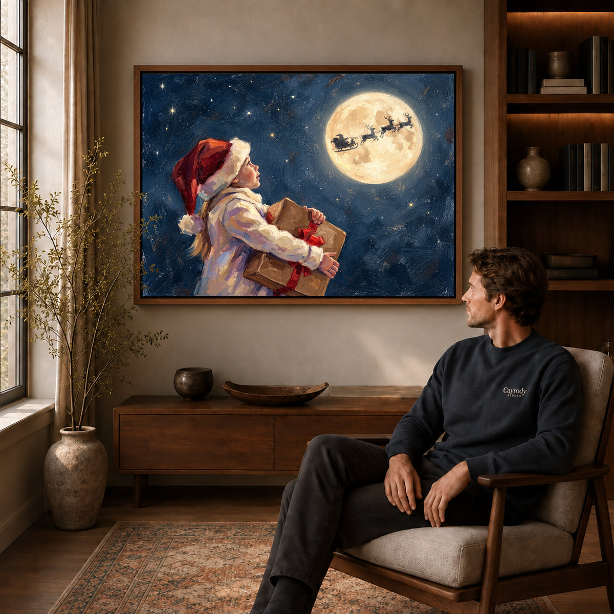 Walnut framed moonlit christmas wish artwork above a seated man in a wood furnished living room.