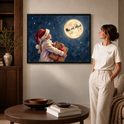 Black framed moonlit christmas wish artwork beside a woman in a warm neutral living room.
