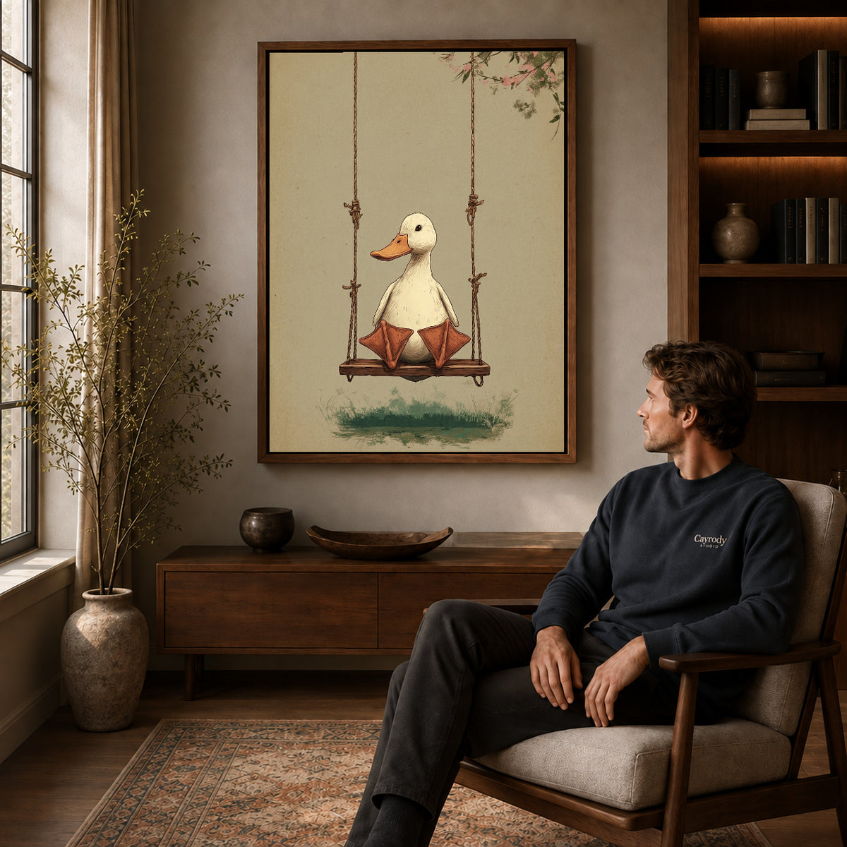 Walnut framed swinging white duck artwork above a seated man in a wood furnished living room.