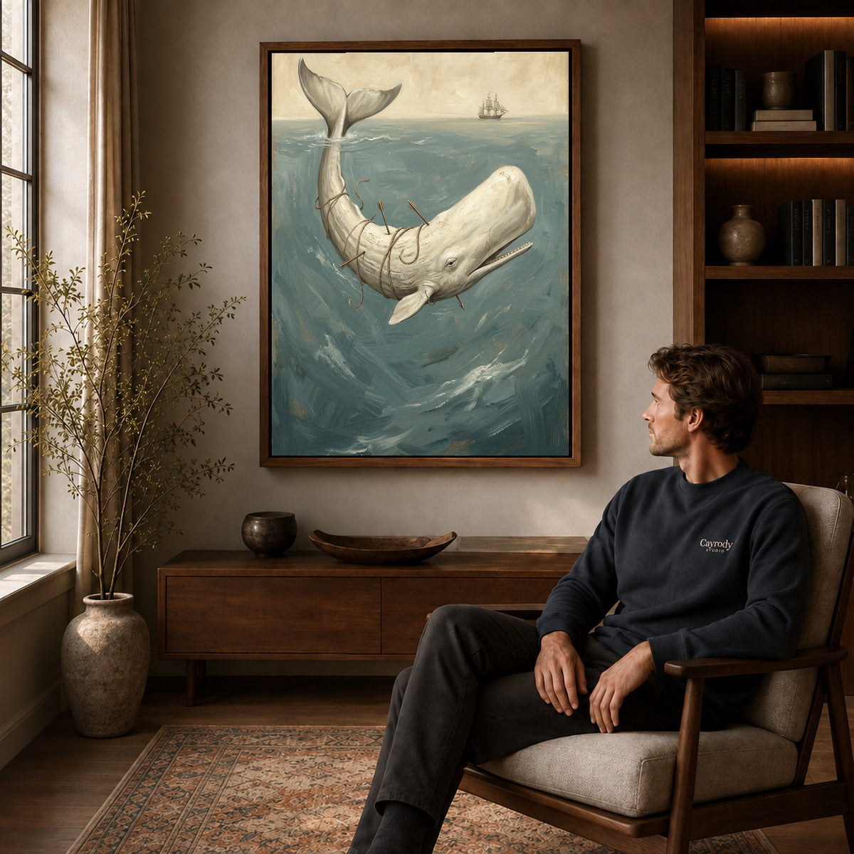 Walnut framed whale ocean voyage artwork above a seated man in a wood furnished living room.
