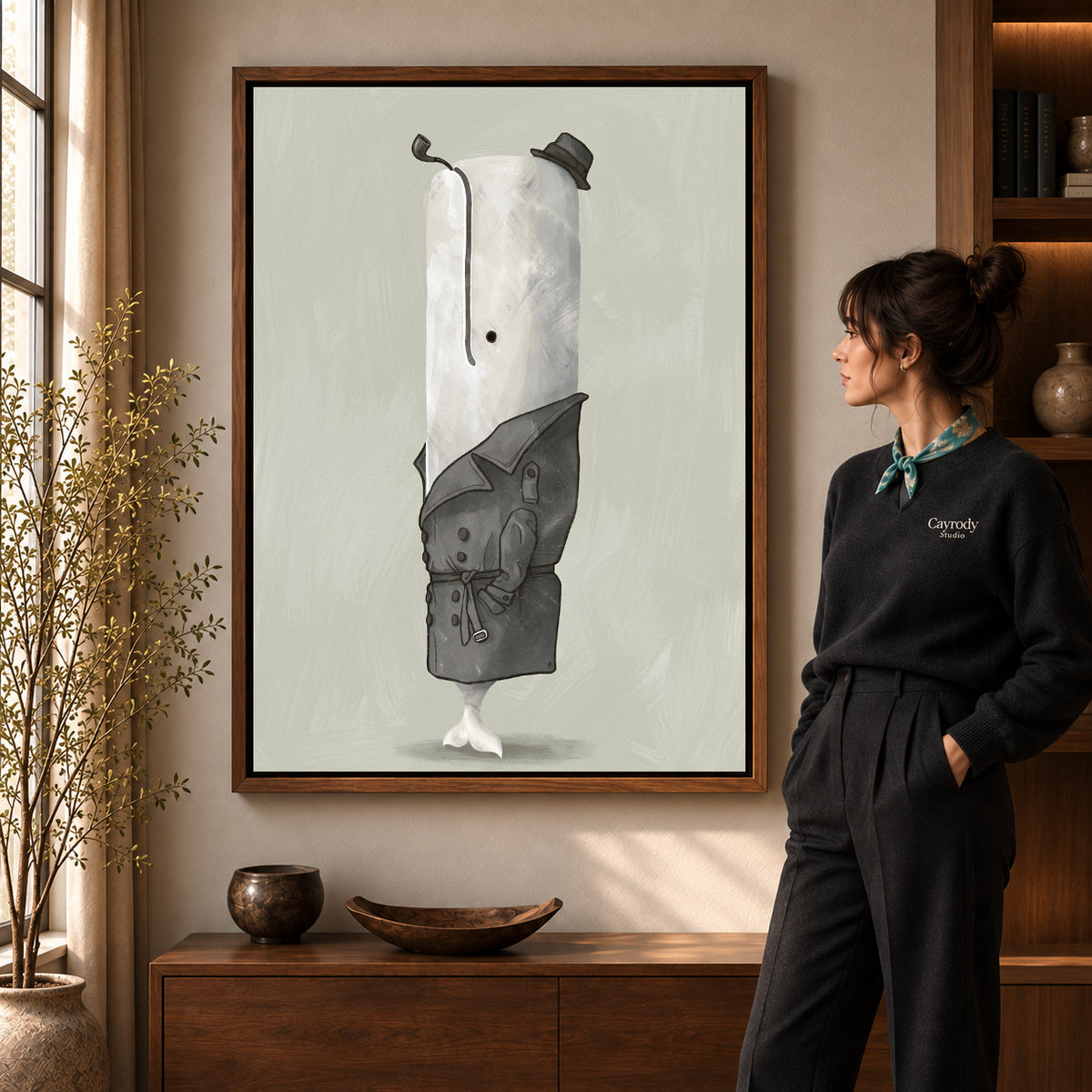Whale Detective Portrait artwork in a walnut frame beside a standing woman in a warm room.