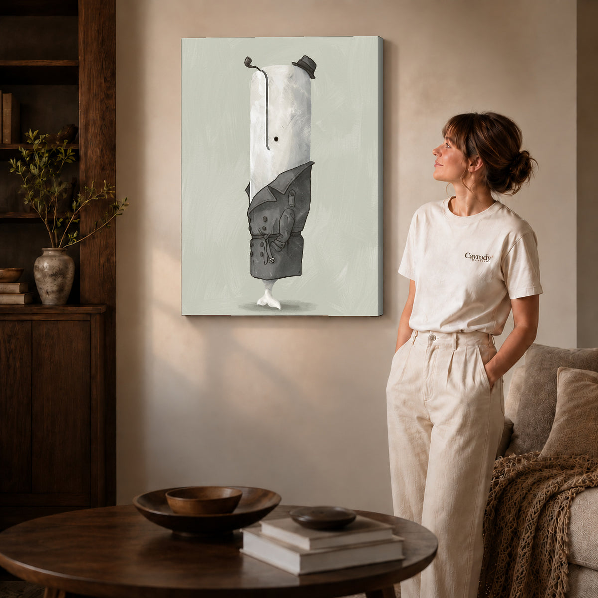 Gallery wrapped whale detective portrait artwork with shaded canvas edges beside a woman wearing cream clothing.