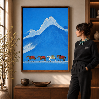 Walnut-framed snowy mountain landscape painting with pack horses beside a sunlit window and credenza
