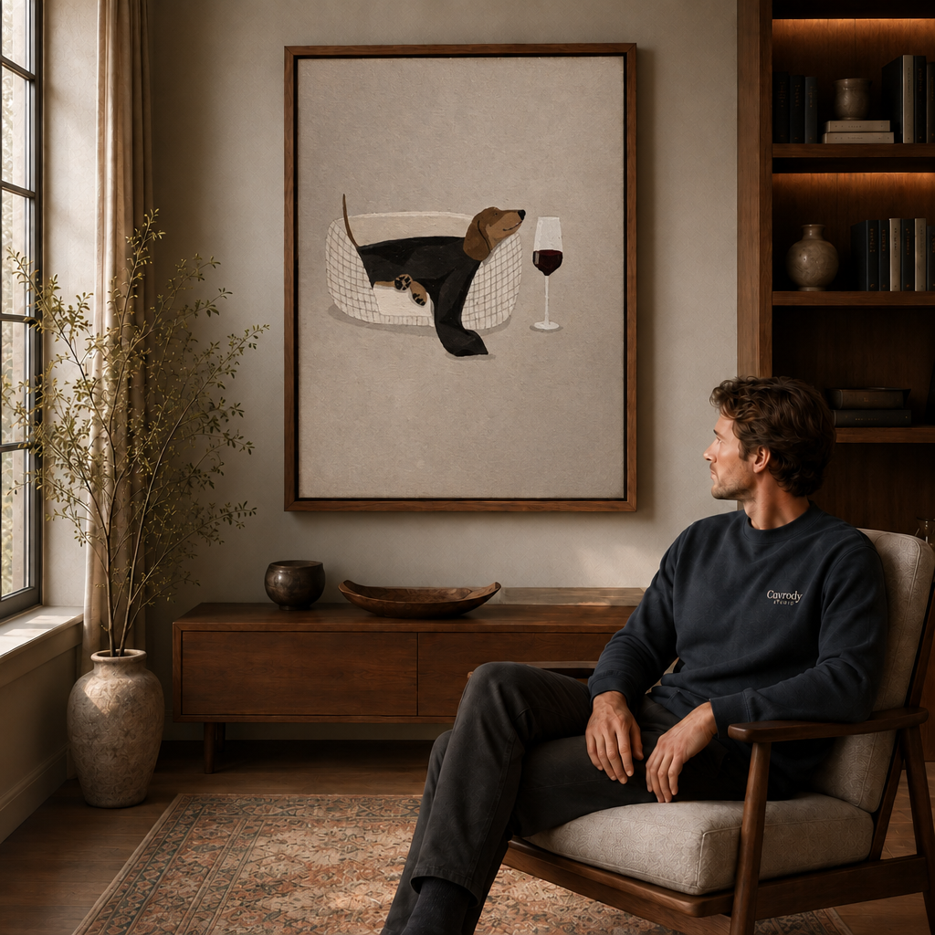 Black cat tea party canvas displayed above a wooden cabinet near a seated man.