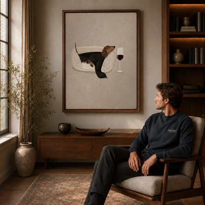 Black cat tea party canvas displayed above a wooden cabinet near a seated man.