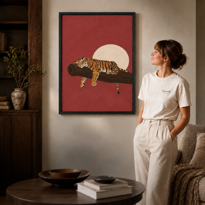 a black-framed sleeping tiger canvas print above a console.