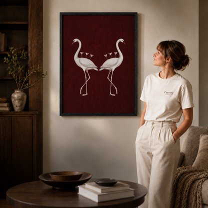 Framed flamingo canvas art shown close up with a white-clad model in a modern living space.