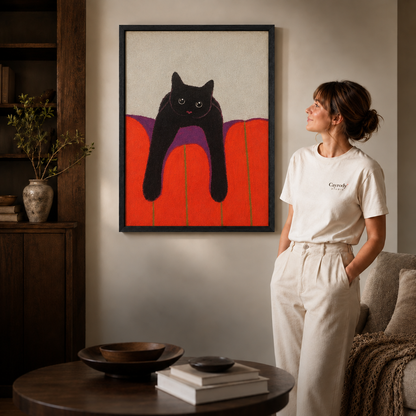 Woman in a white t-shirt stands beside black cat canvas wall art in a black frame, modern living room.