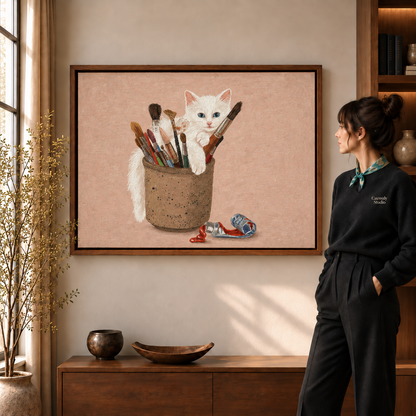 White kitten peeking from a cork paintbrush pot in whimsical cat wall art, walnut frame