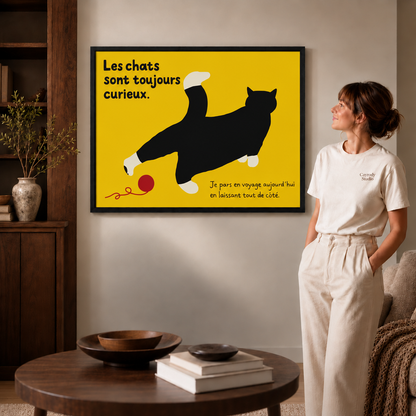 Black-framed black cat canvas wall art brightens a living room with bold yellow and French text.