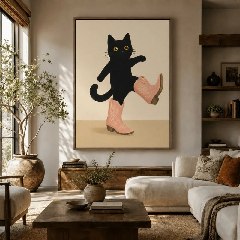Playful cat wall art in pink cowboy boots hanging in bright modern living room above white sofa