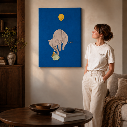 Gallery-wrapped whimsical elephant canvas wall art beside a woman in white, a round table, and a sofa.