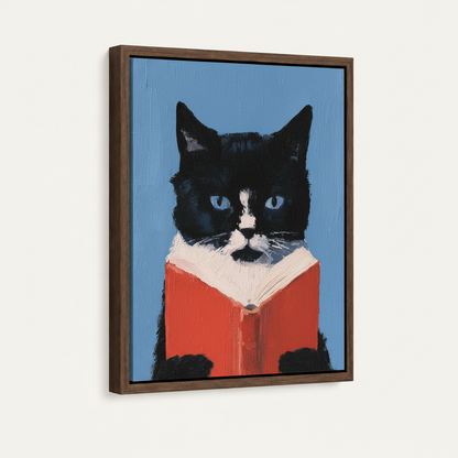 Tuxedo cat with red book framed canvas print — angled product view on white background
