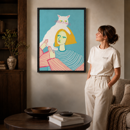Black framed cat woman wall art shown close up living space.
