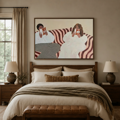 Bold figurative canvas wall art of two women reading displayed above bed in warm neutral bedroom
